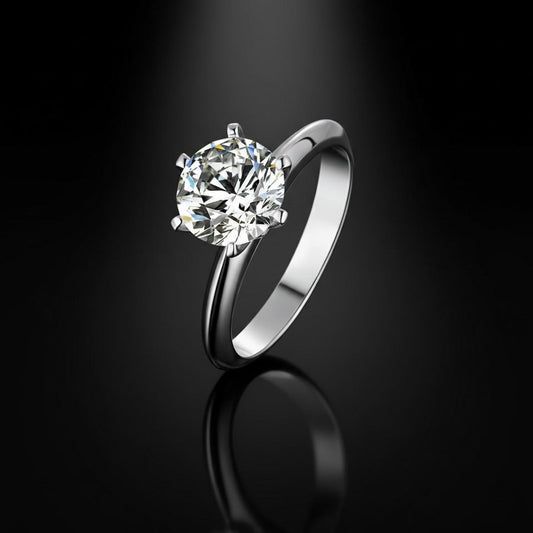 Silver ring with a large diamond on a black background