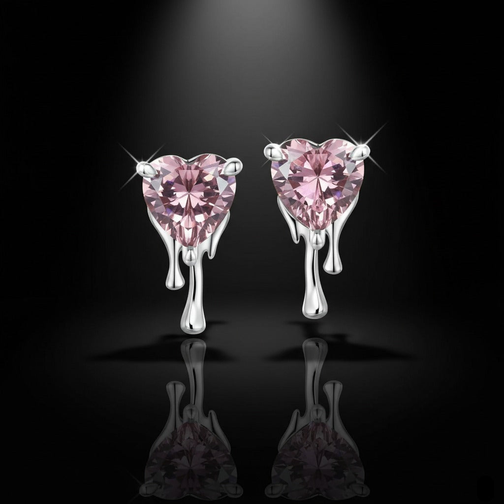Heart-shaped pink gemstone earrings on a black background