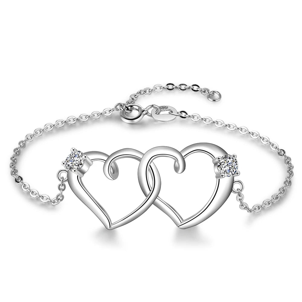 A 925 sterling silver bracelet with an intertwined heart chain design and small zirconia stones, featuring a lobster clasp.