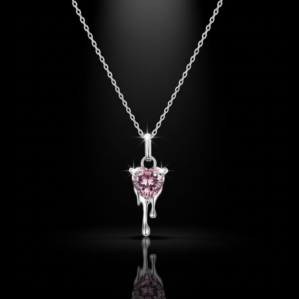Pink heart-shaped pendant on a silver chain against a black background