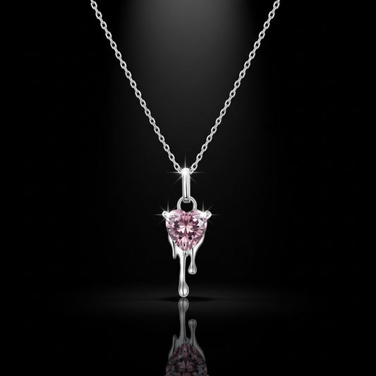 Pink heart-shaped pendant on a silver chain against a black background
