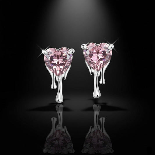 Heart-shaped pink gemstone earrings on a black background