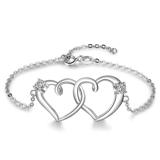 A 925 sterling silver bracelet with an intertwined heart chain design and small zirconia stones, featuring a lobster clasp.